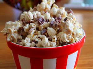 Cran apple white chocolate popcorn, served in a red and white bowl,