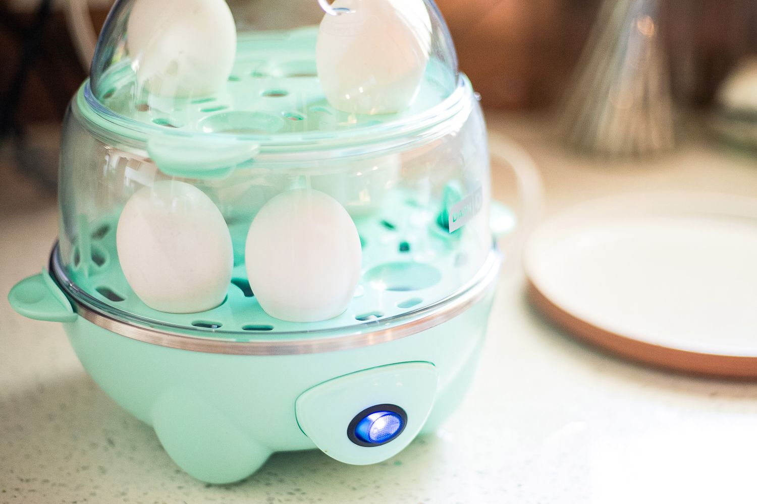 Hard boiled eggs cooking in the Dash egg cooker