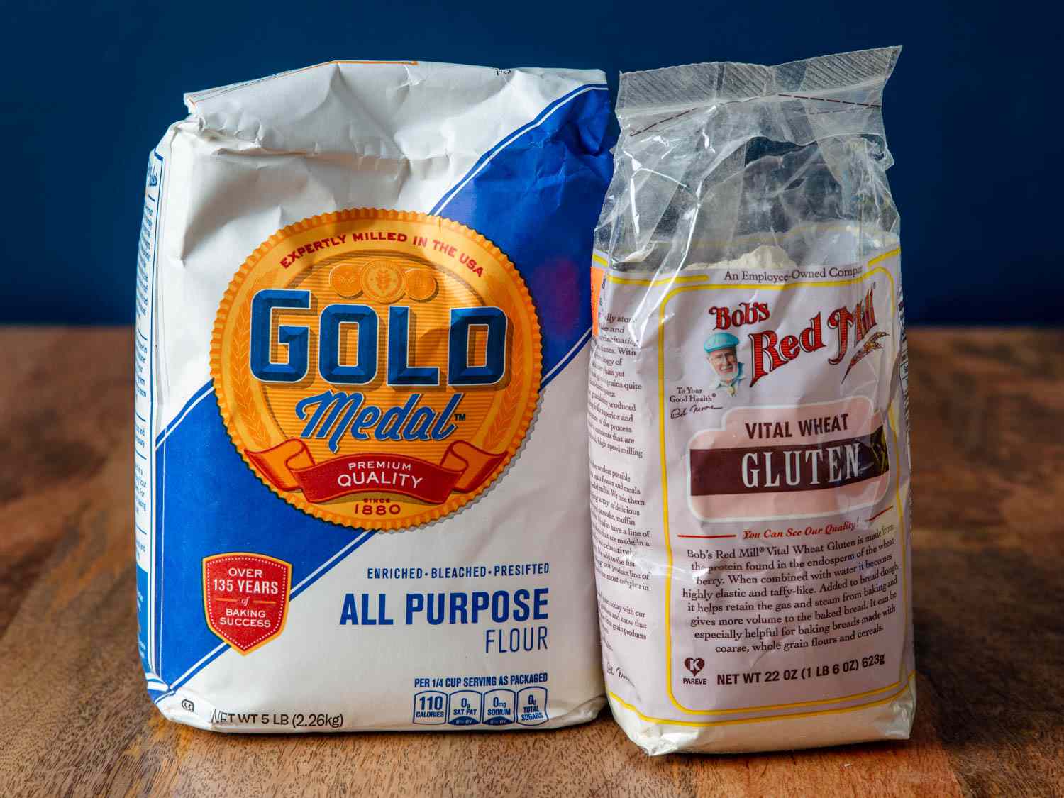 A bag of Gold Medal all-purpose flour next to a bag of Bob's Red mill vital wheat gluten