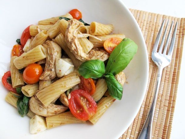 Overhead view of a plate of Caprese Chicken Pasta, made with rigatoni.