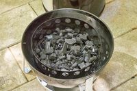 Charcoal inside the Weber 18-Inch Smokey Mountain Cooker
