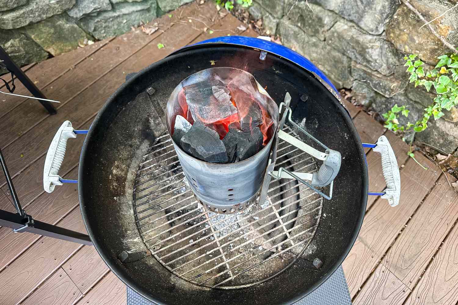 Jealous Devil Chunx Lump Charcoal lighting in a chimney starter on a barbecue grill