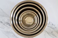 Set of Vollrath stainless steel mixing bowls on a marble surface