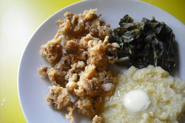 Fried Chicken Gizzards on a plate with some cooked greens