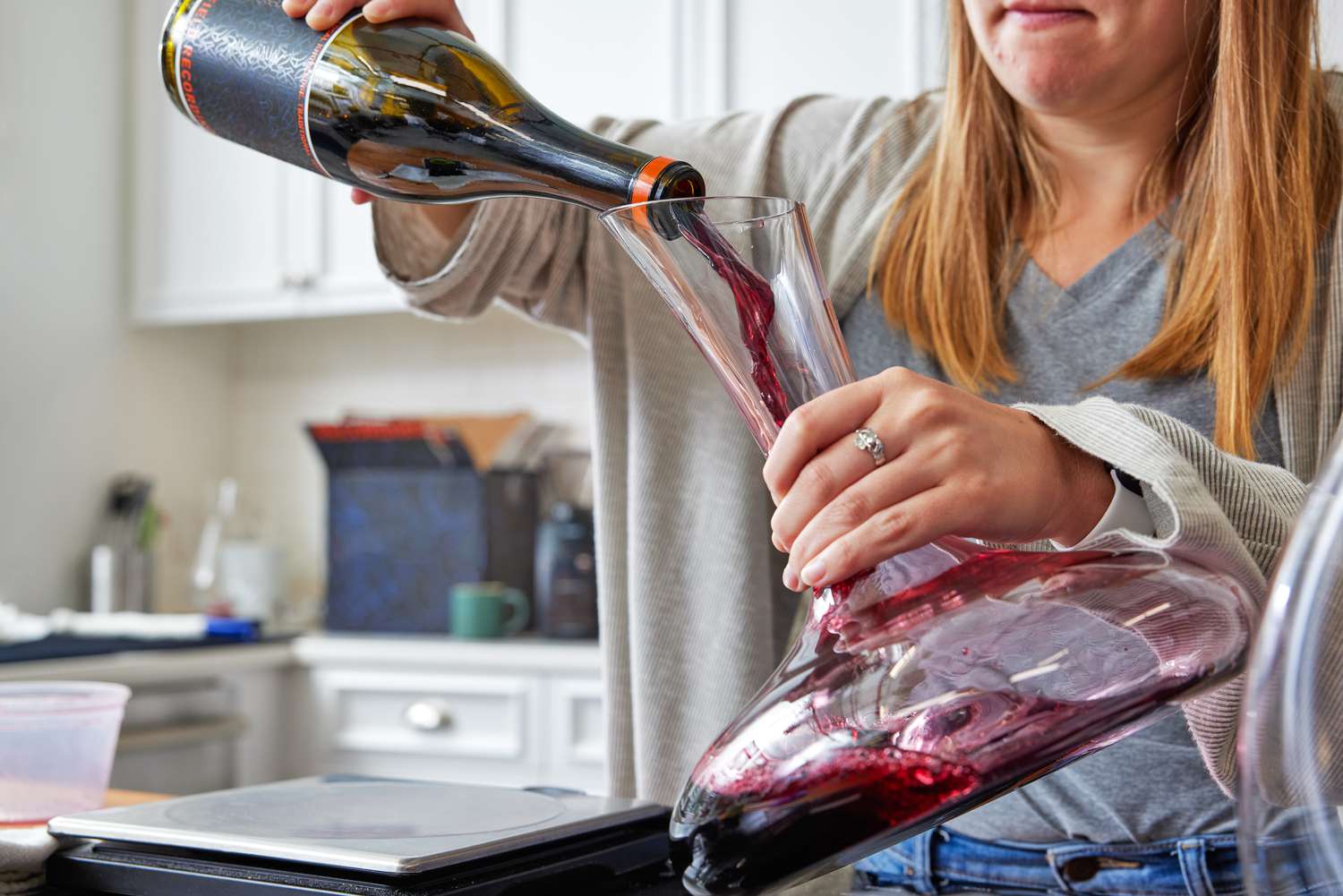 Red wine being decanted into a standard wine decanter held at an angle