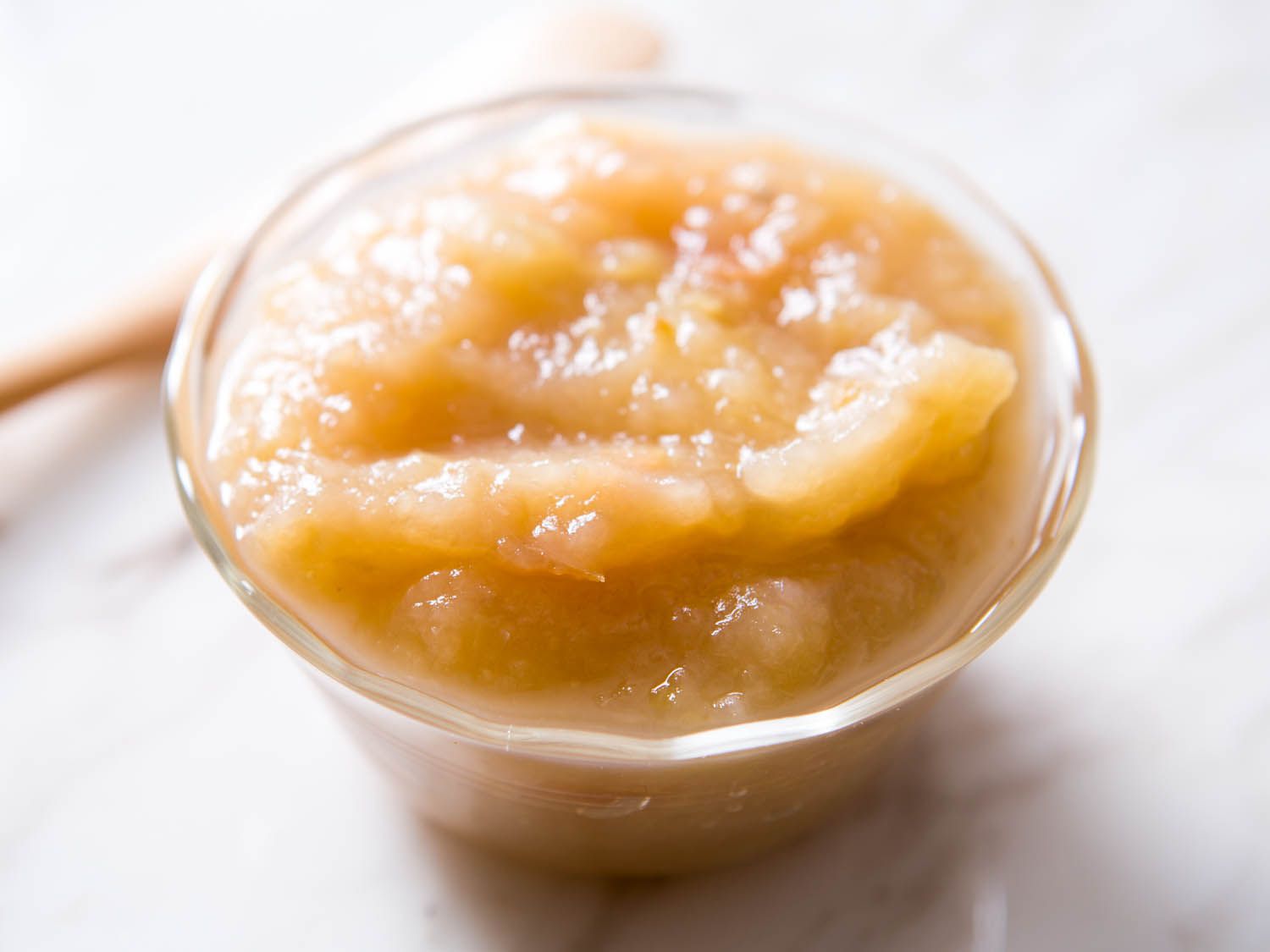A glass bowl of applesauce.