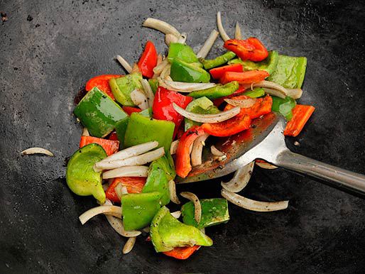 Vegetables being stir-fried in a wok.