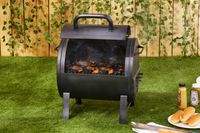 The Char-Griller portable charcoal grill cooking hot dogs.