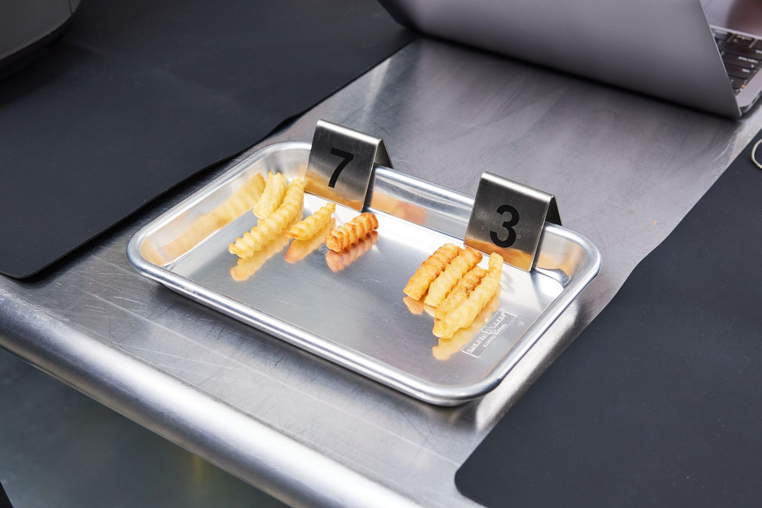 Two sets of French fries on display for crispiness comparison.