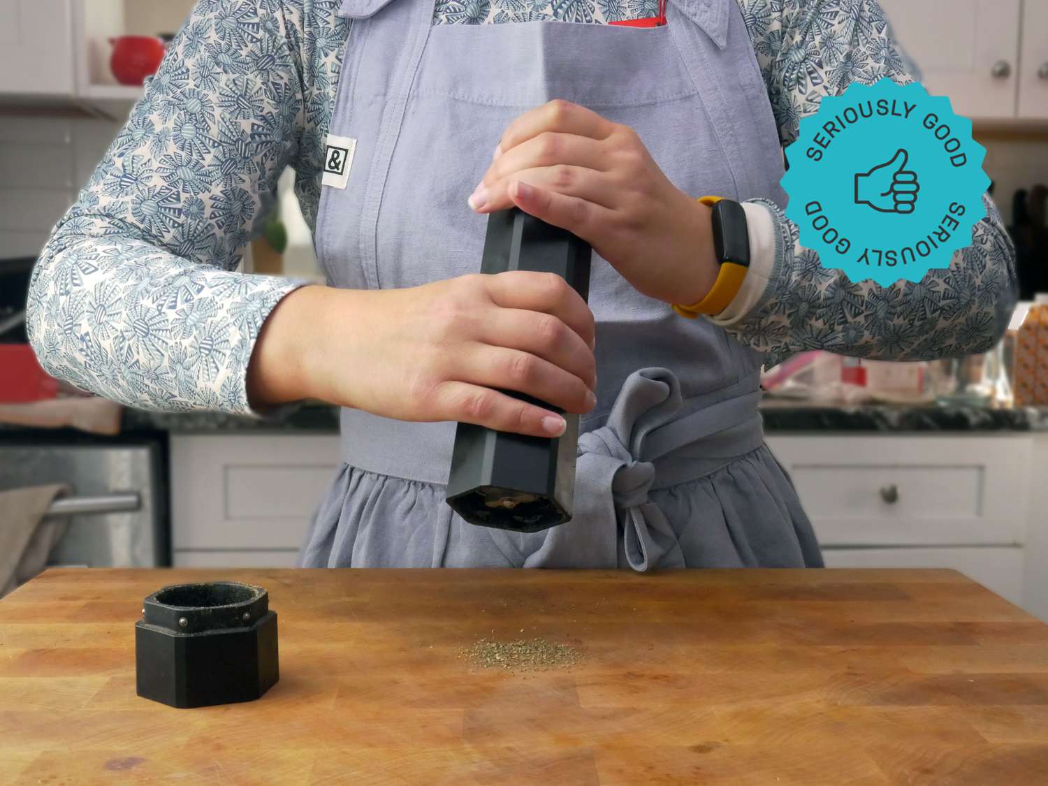 a person using the hexmill to grind pepper