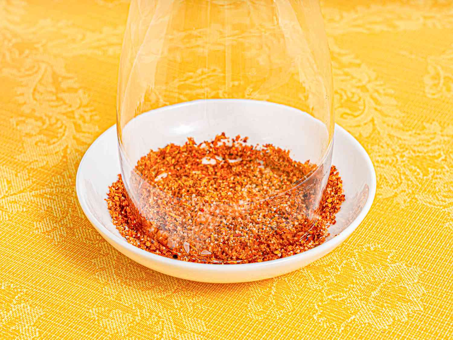 Side view of rimming glass with tajin