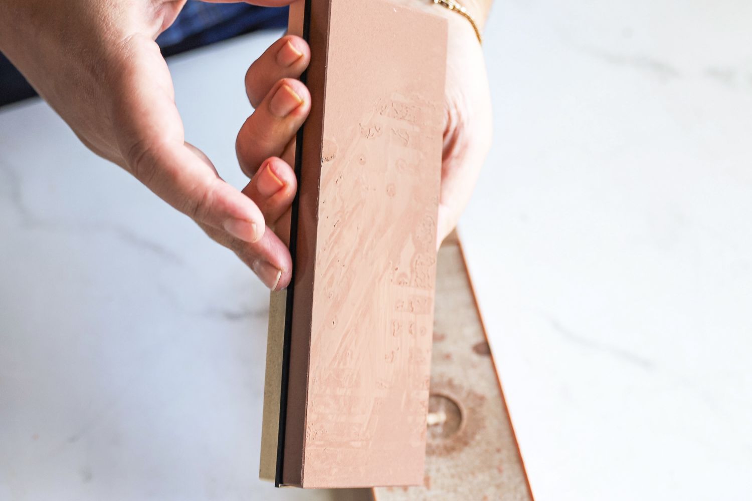 A person holding the King Whetstone sharpening set