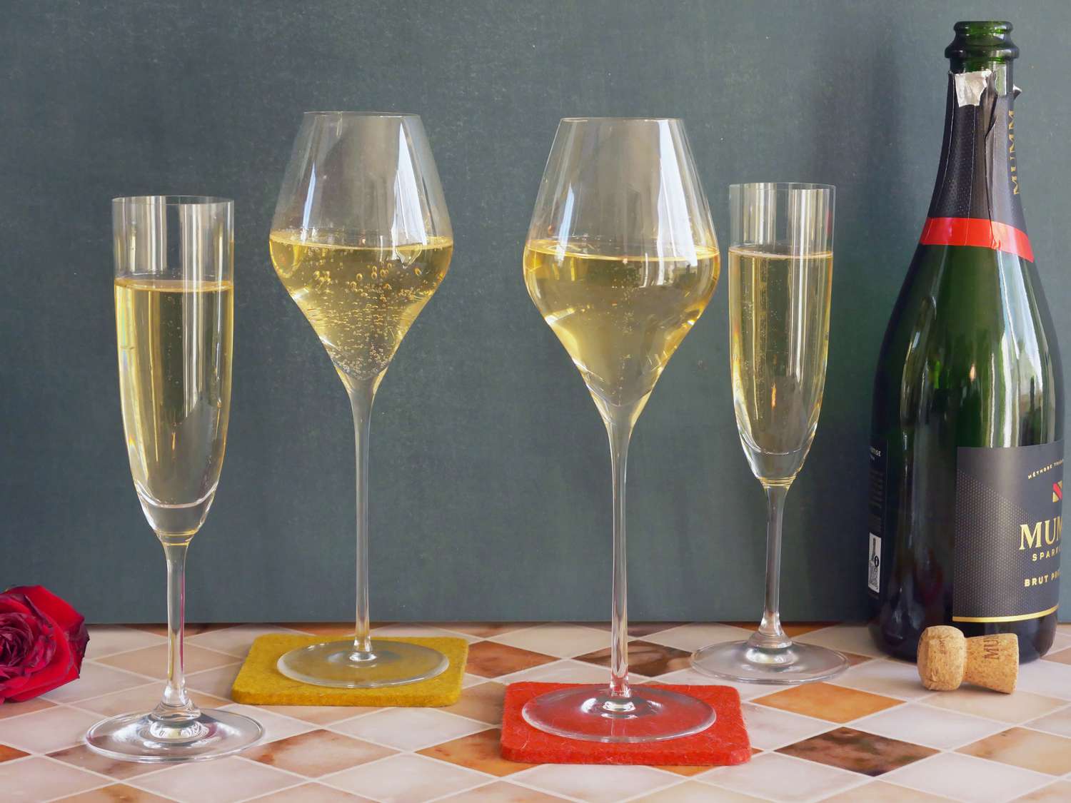 a variety of champagne glasses filled with sparkling wine