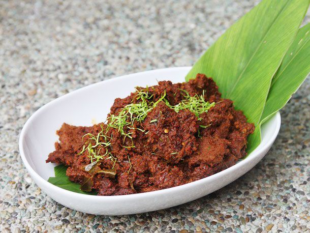 Beef rendang in an oval white bowl 