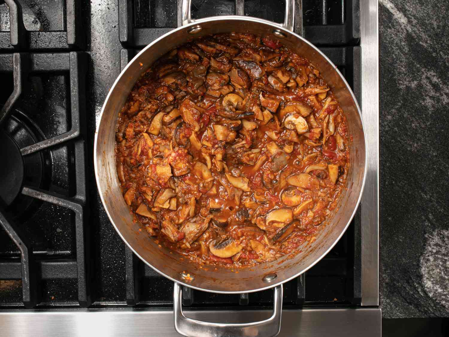 Mushroom ragu cooking in a saucepan.