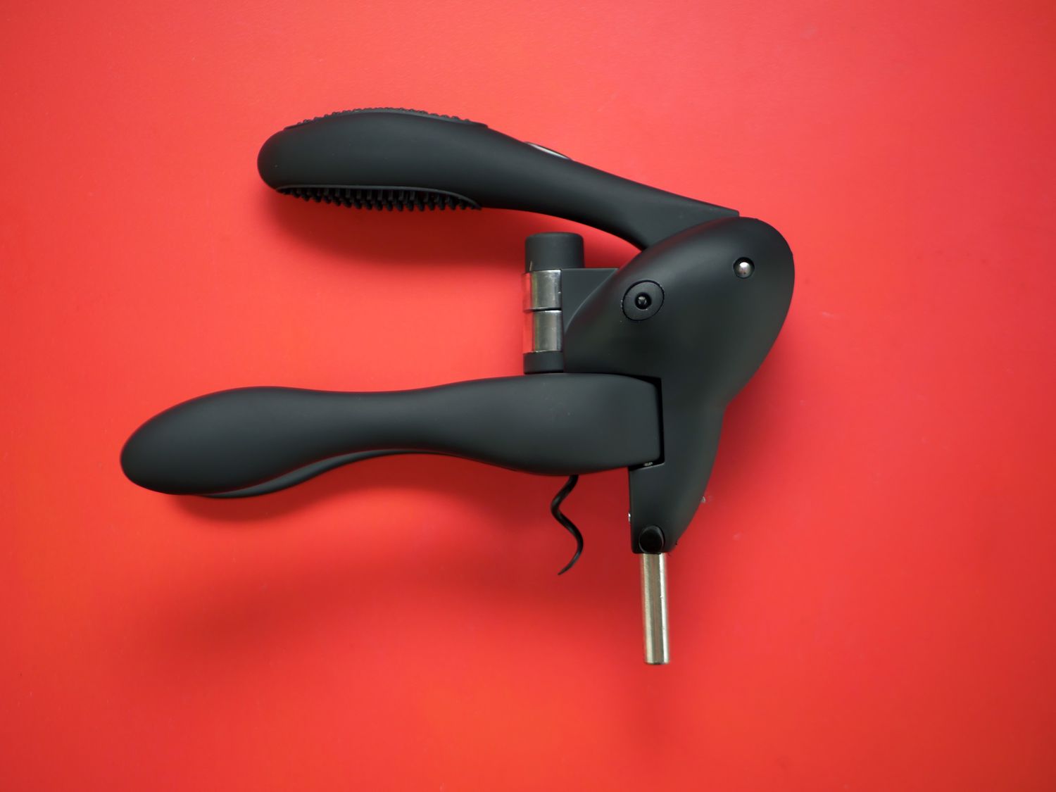 Rabbit wine opener on a red surface