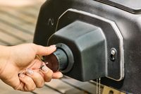 A person turns a dial on the Ooni Karu 2 Pro Multi-Fuel Pizza Oven