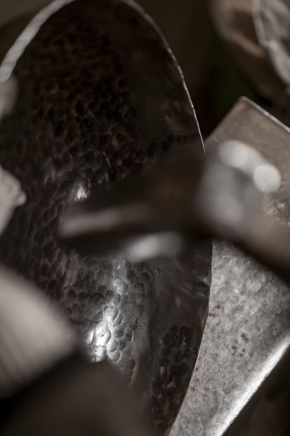 A cropped view of details in a hand-hammered wok