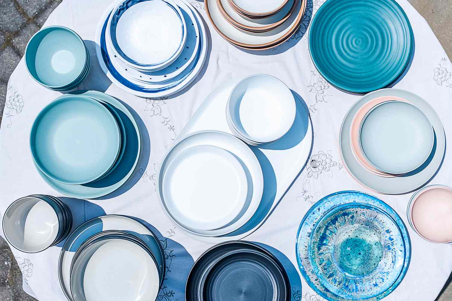 An overhead view of a table covered in outdoor dinnerware sets