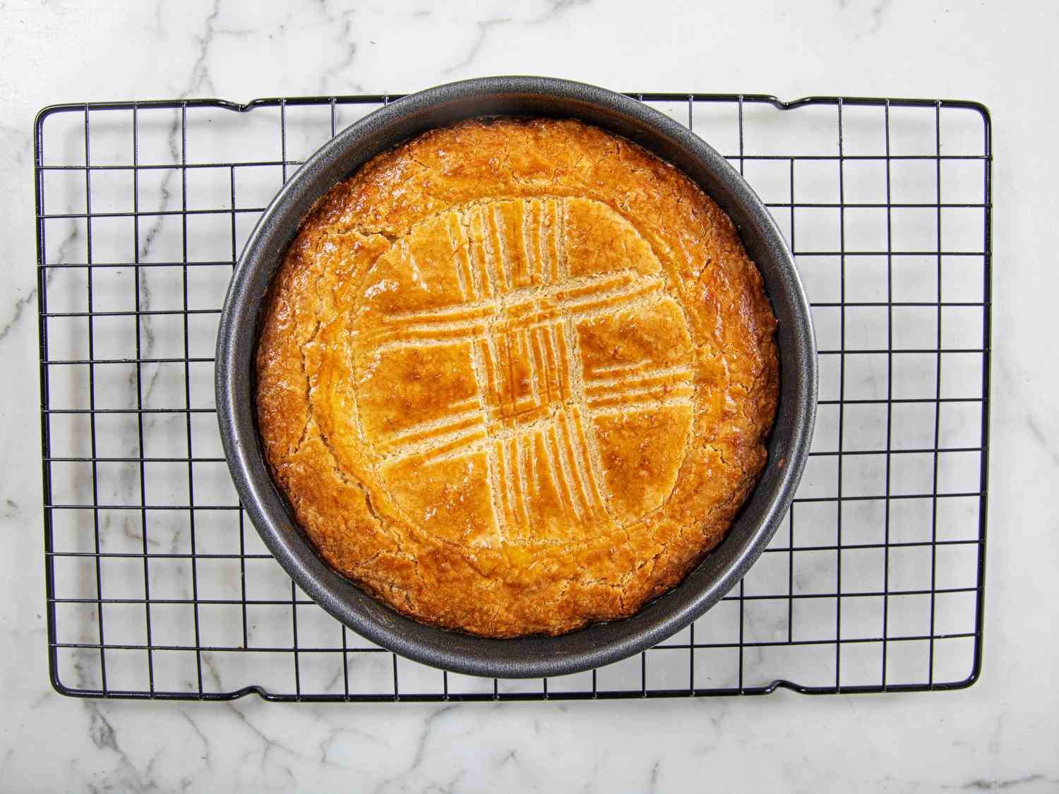 Finished gateau basque resting on a wire rack