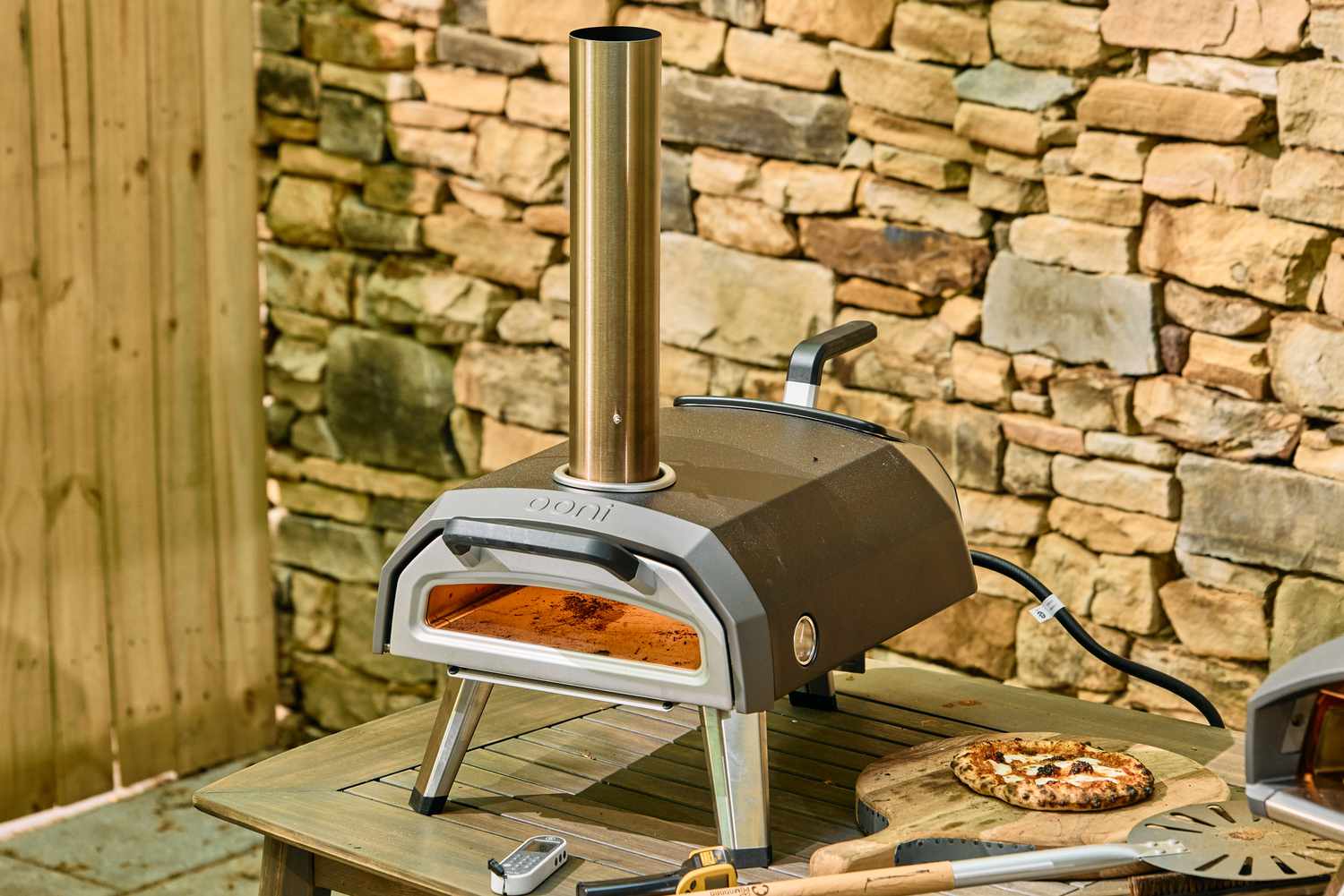 The Ooni Karu 2 Multi-Fuel Pizza Oven outside on a table