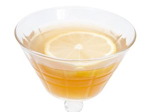 A closeup of a The King's Waes Hail cocktail, served in a strange coupe glass.