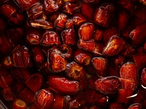 Closeup of sliced dates soaking in liquid