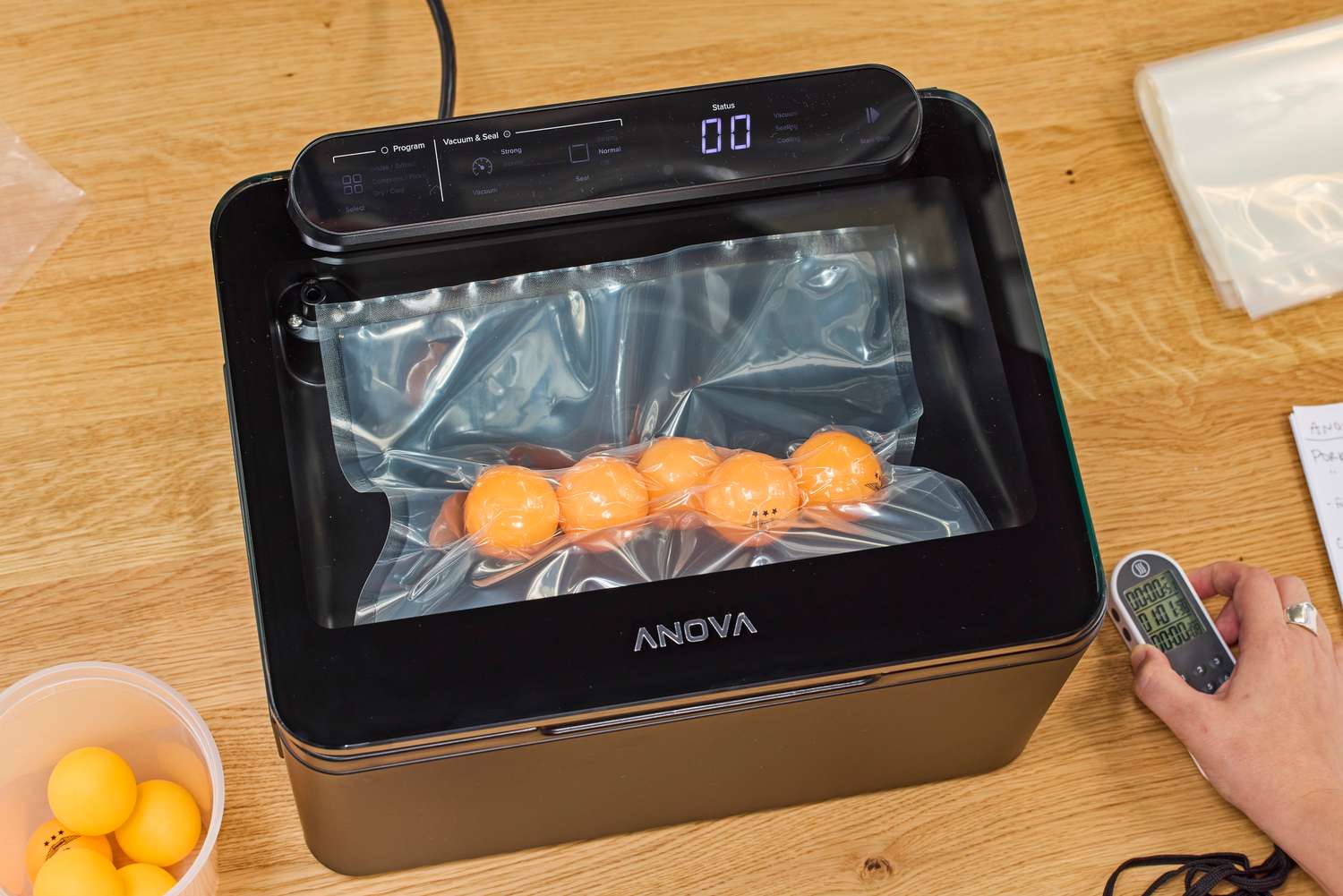 A bag of ping pong balls is vacuum sealed in the Anova Precision Chamber Vacuum Sealer