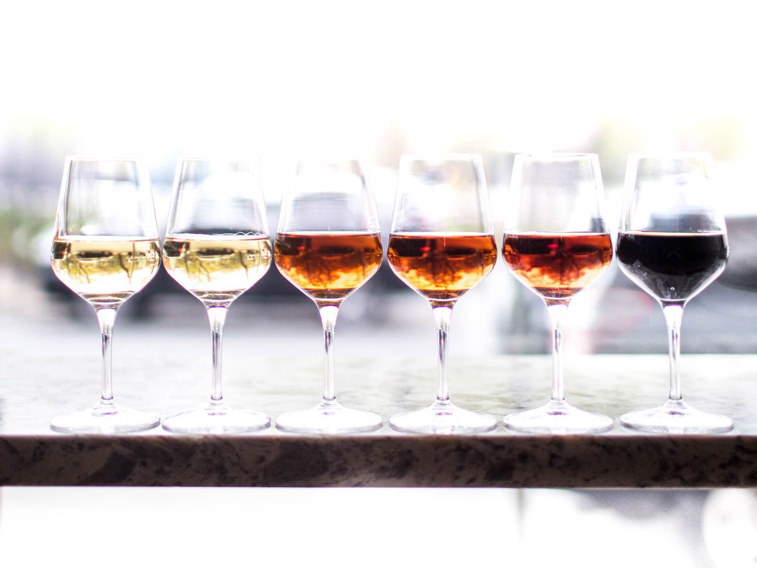 Six wineglasses of sherry, ranging from light to dark
