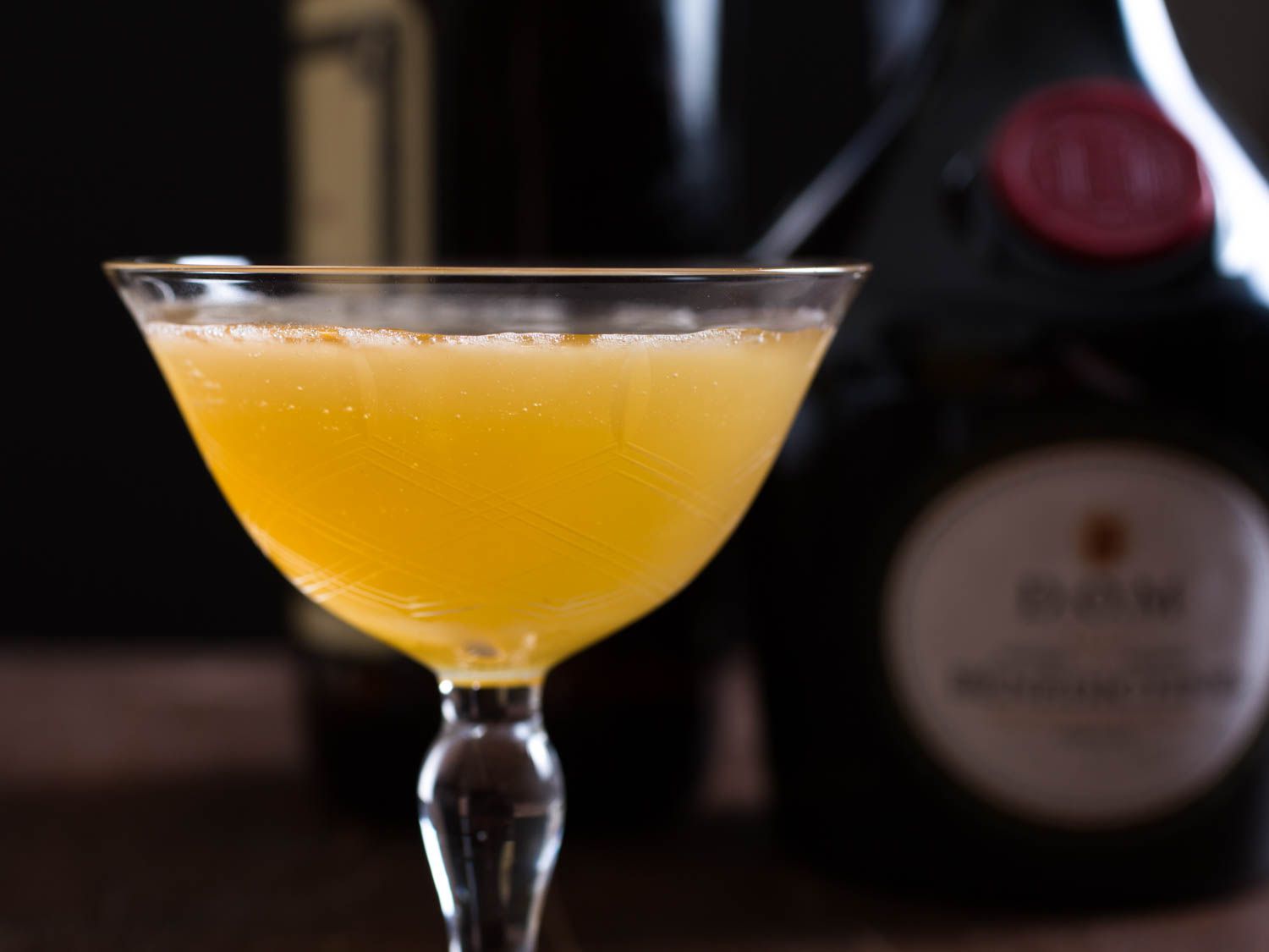 Closeup profile view of a frisco sour cocktail served in a coupe glass.