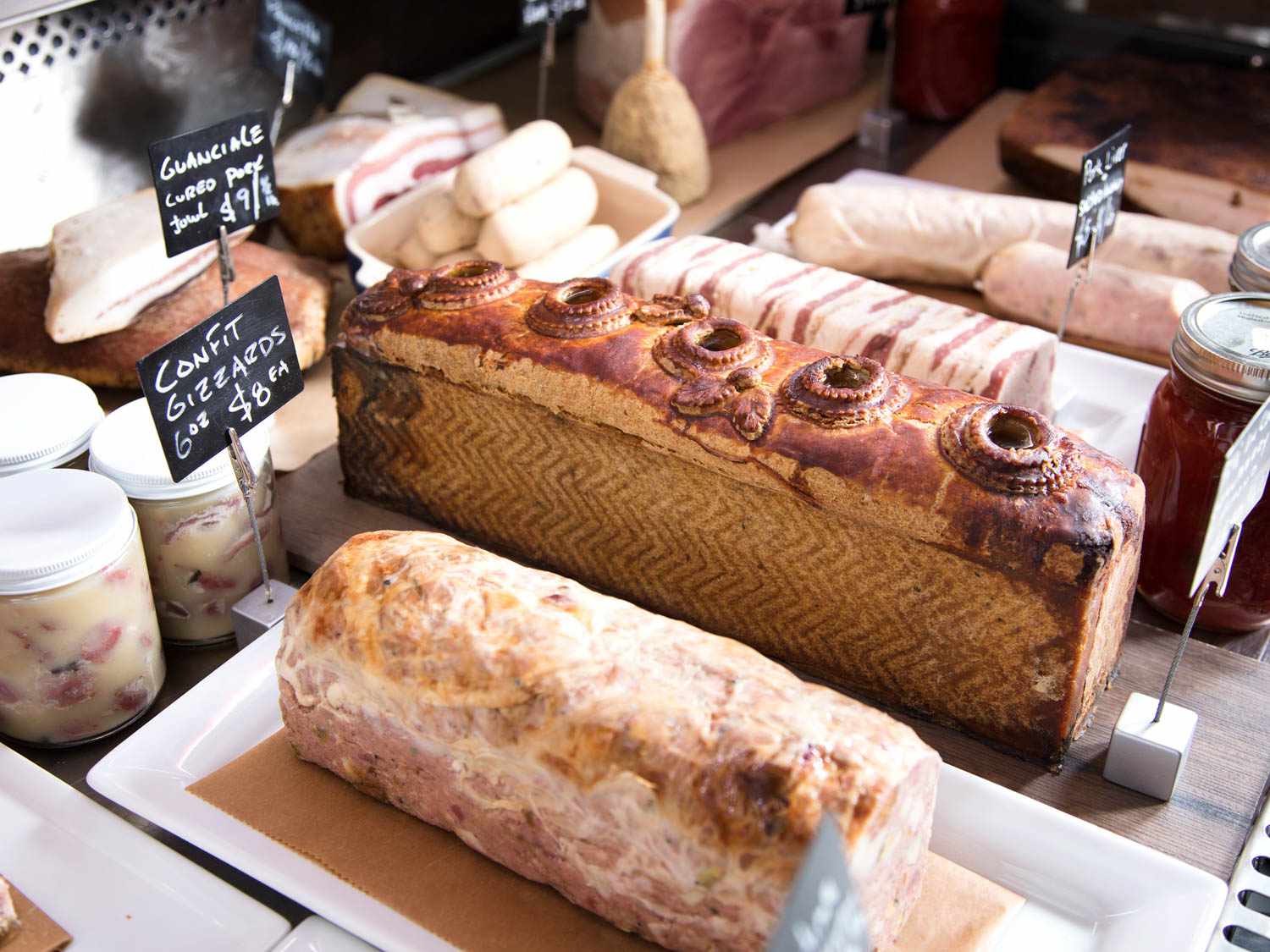 Pâté en croûte, gizzard confit, and other charcuterie on display at 8 Hands Farm.