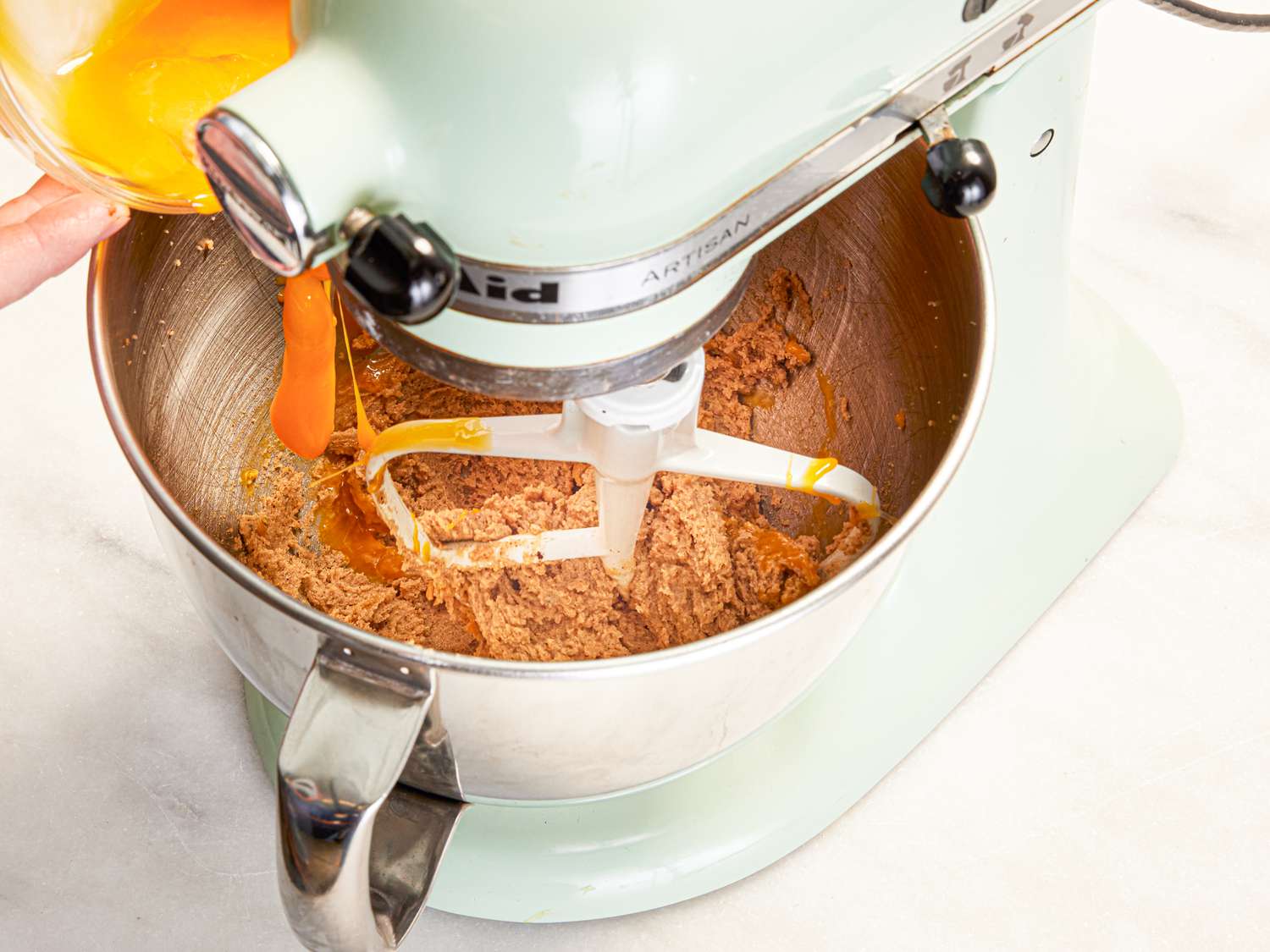 Overhead view of adding yolks to batter
