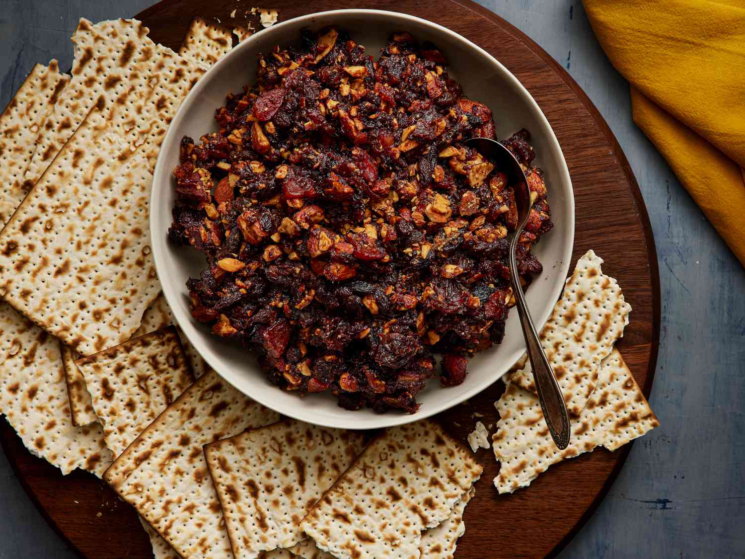 Overhead view of charoset in a bowl surrounded by matzah crackers