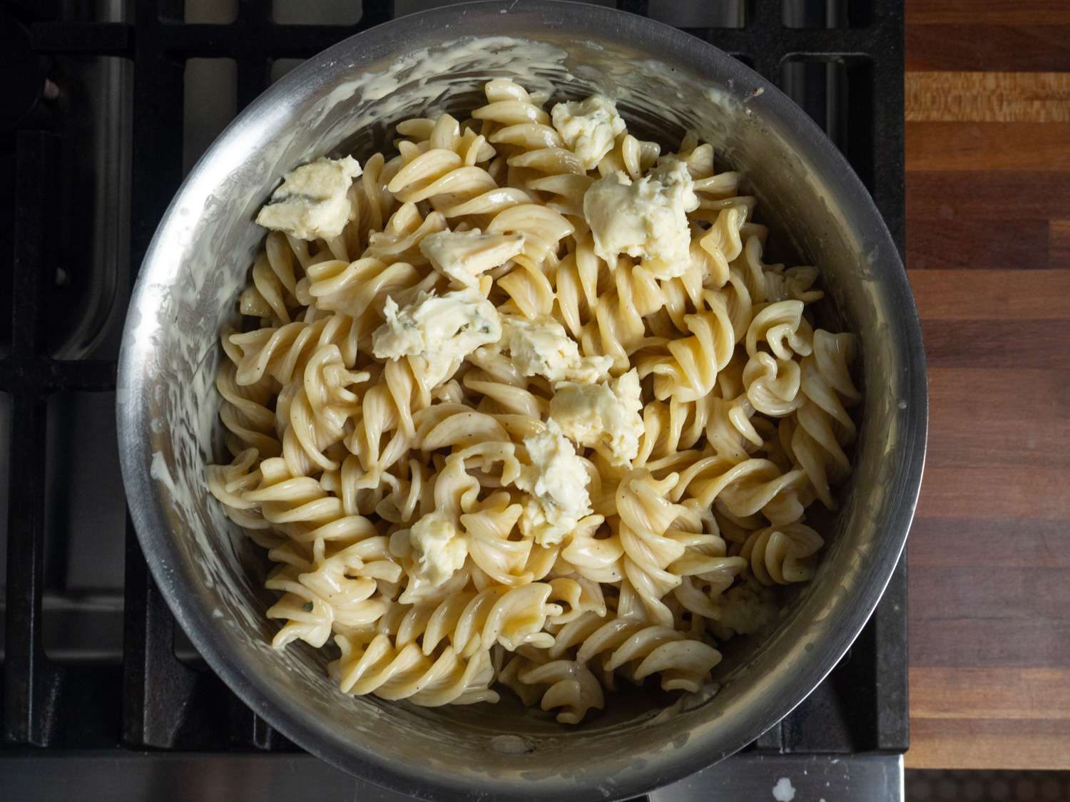 Chunks of gorgonzola dolce are added to the sauced pasta last.