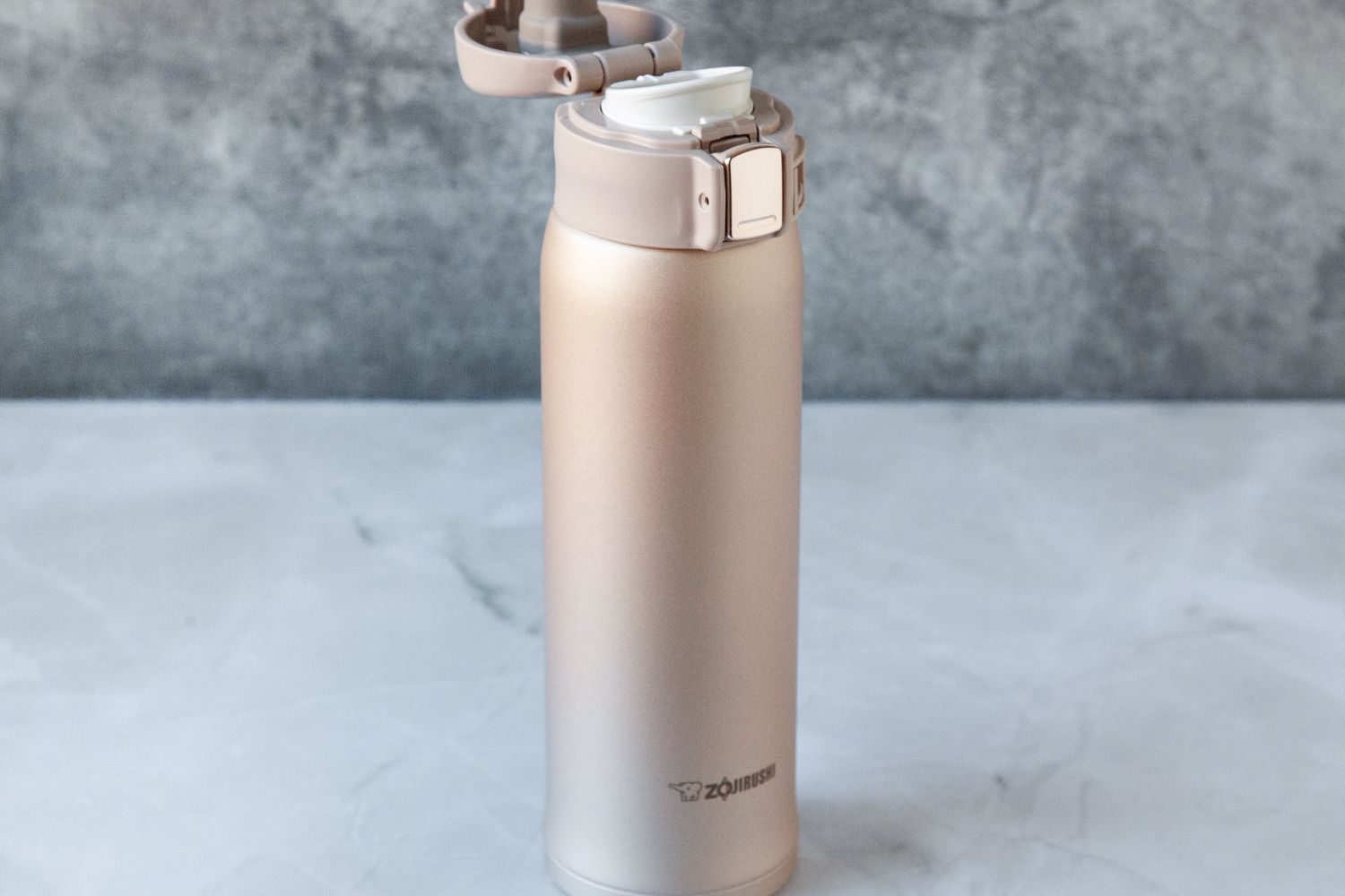 The Zojirushi travel mug with its lid open.