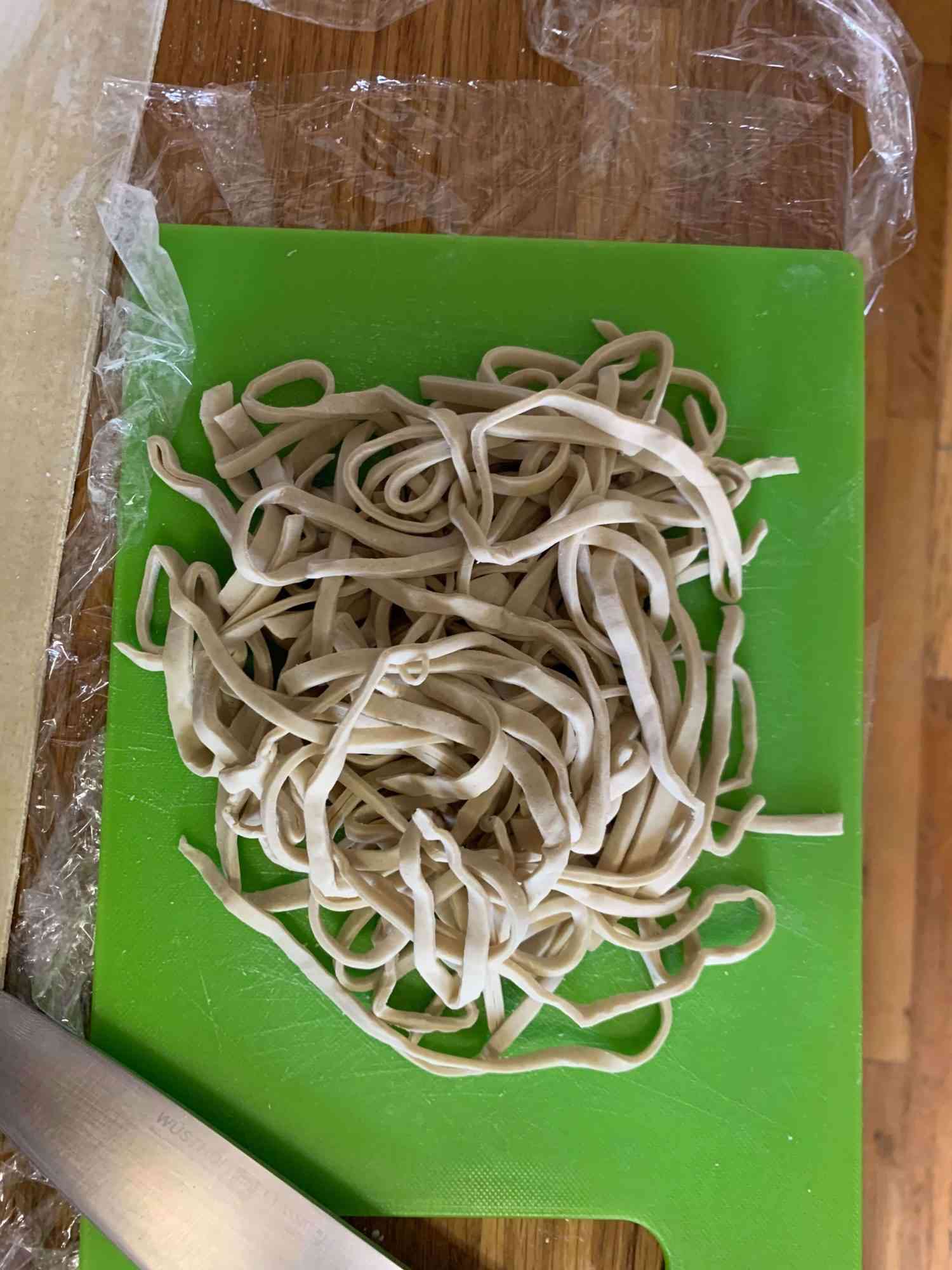 fresh ramen noodles after cutting and squeezing on a cutting board