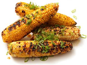 4 grilled cobs of corn with soy butter and scallions.