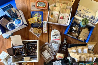 a variety of gift baskets contents on a wooden countertop