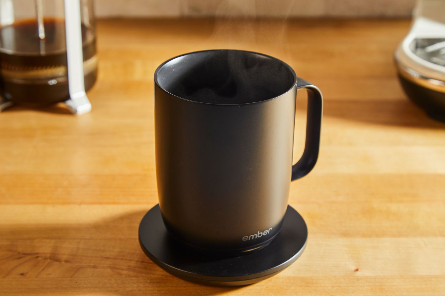 A close-up picture of the Ember coffee mug, full of steaming coffee