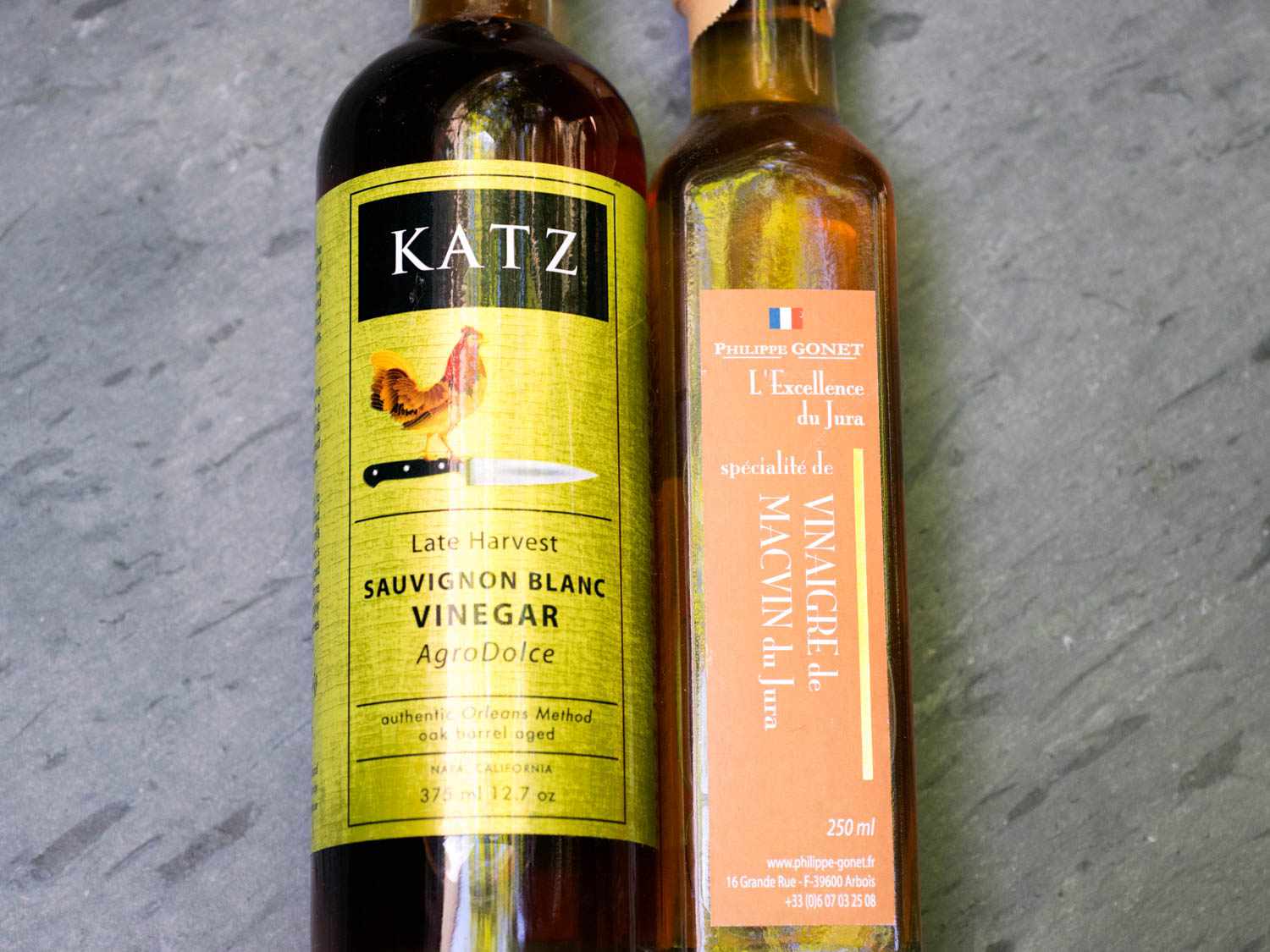 Two bottles of white wine vinegar.