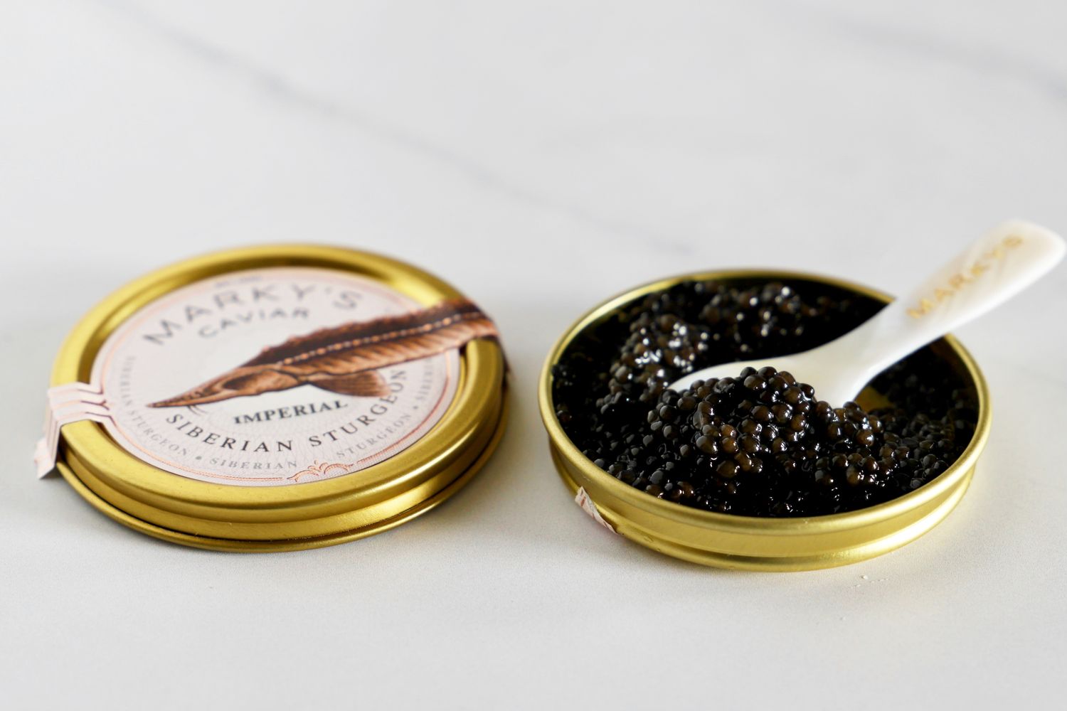 a tin of imperial sturgeon caviar with a Marky's branded mother-of-pearl spoon set inside