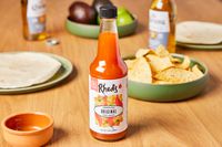 The Rhed's house sauce on a countertop with tortilla chips.