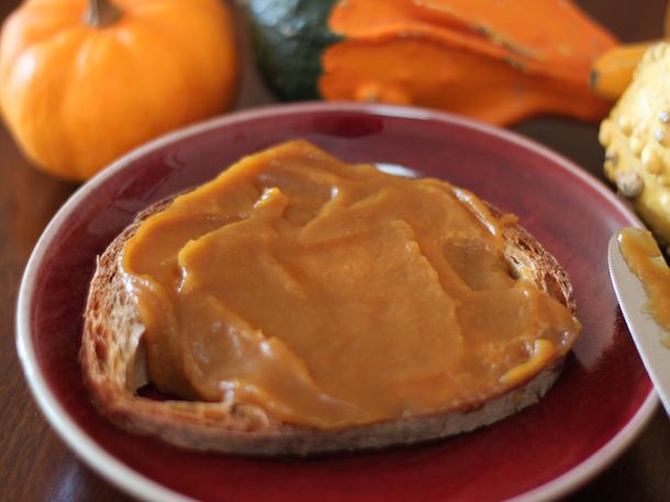 Closeup of a slice of sourdough toast spread with a thick layer of pumpkin butter.