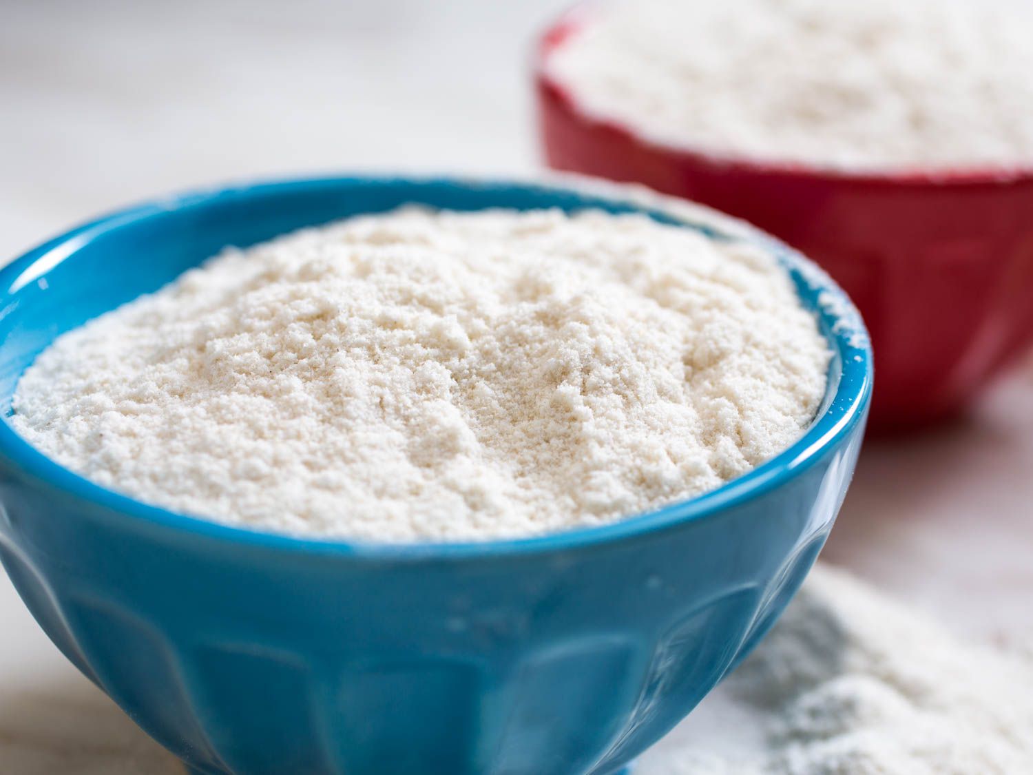 A blue prep bowl of low-allergen gluten-free flour.
