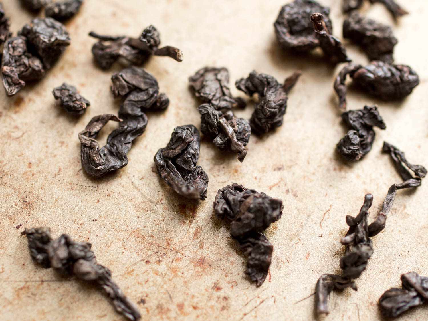 A closeup of dried tieguanyin oolong tea leaves