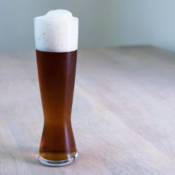 A tall pint glass of amber-colored rauchbier.