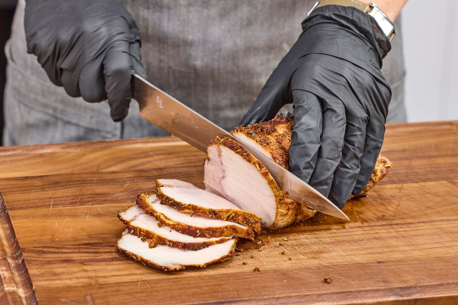 A person slices meat with the Miyabi Koh 9.5 Inch Slicing Knife