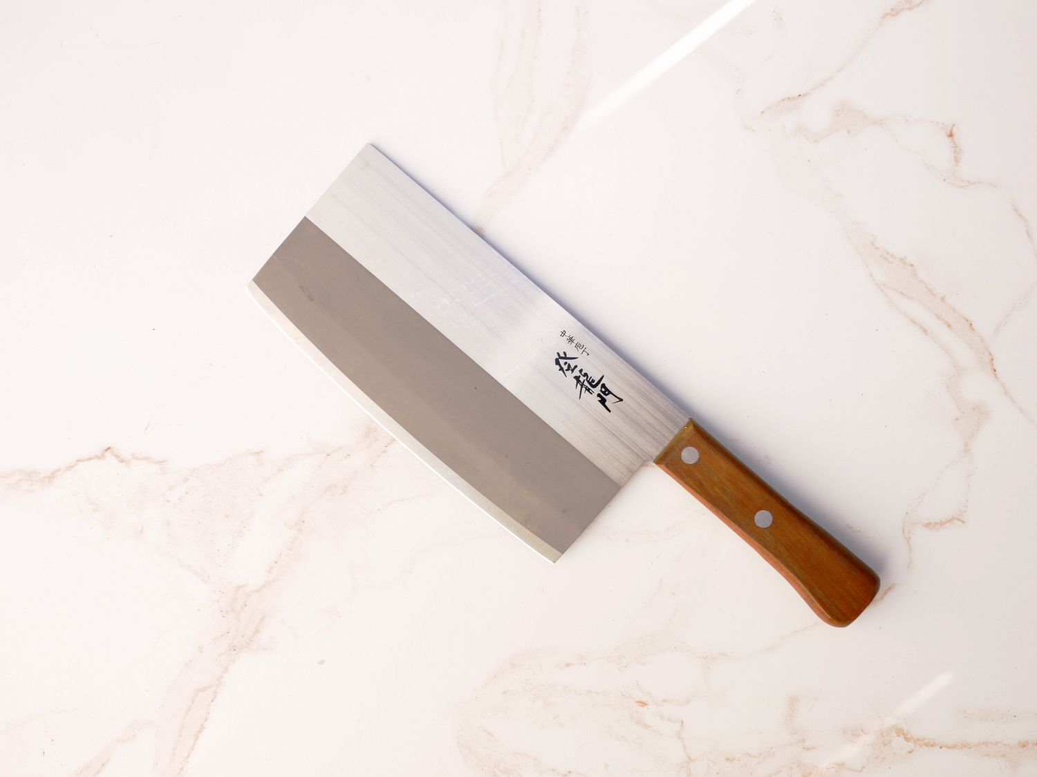 Tojiro cleaver on pale pink marble surface