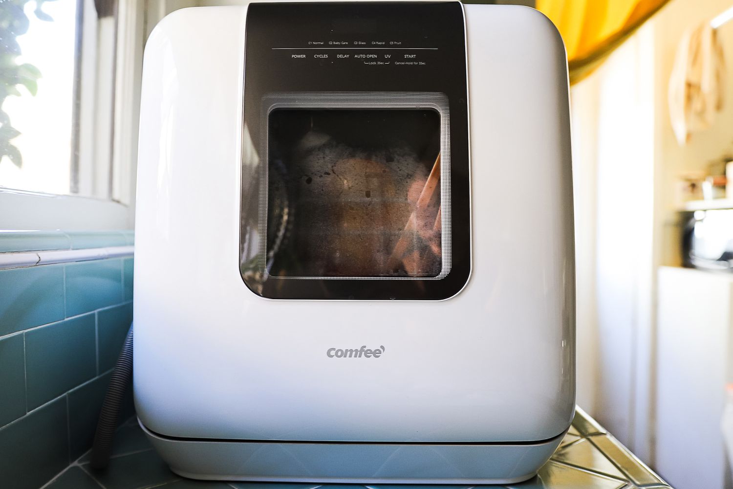 The Comfee countertop dishwasher on a kitchen counter.