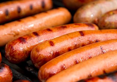 Closeup of grilled hot dogs and sausages on a grill